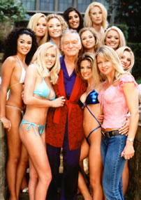Colleen Kelly posing with Hugh Hefner and the Bunnies at the Playboy Mansion